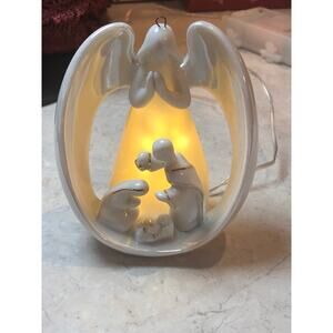 Angel Nativity. Angel with arms wrapped around The Holy Family Porcelain